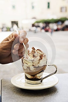 Young man having a mocha latte coffee outdoors