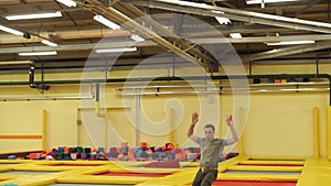 Young man having much fun on a trampolines