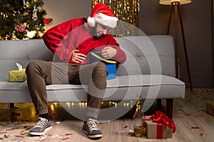 Young man having nausea at home after Christmas party