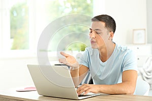 Young man having online dating at home