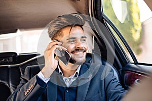 Young man having phone call in limousine