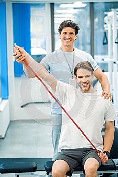 Young man having a physical therapy session with a doctor