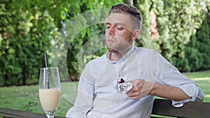 Young Man Having a Snack in the Park