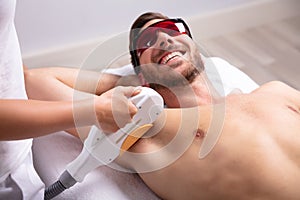 Young Man Having Underarm Laser Hair Removal Treatment