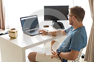 Young man having Zoom video conferencing call via computer. Home office. Stay at home and work from home concept during