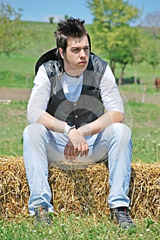 Young man on hay bale
