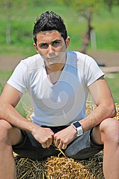 Young man on hay bale