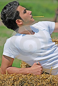 Young man on hay bale