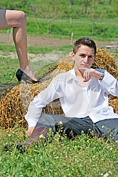 Young man on hay bale