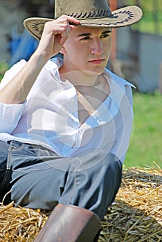 Young man on hay bale