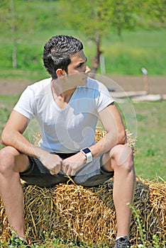 Young man on hay bale