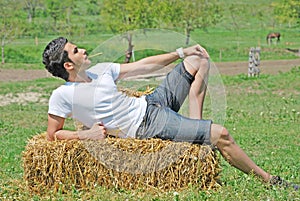 Young man on hay bale