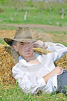 Young man on hay bale