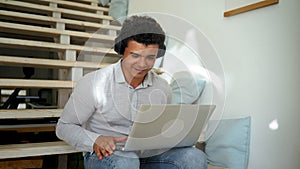 Young man in headphones enjoys dynamic music moving head