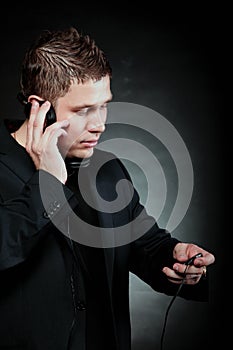 Young man with headphones use mp3 music player