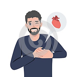 Young man with heart disease holding his chest. Heart attack symptom