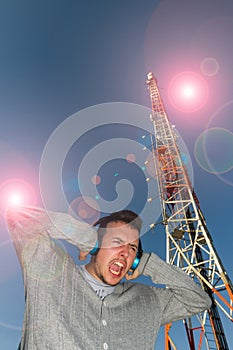 Young Man with Helmets and Telecommunications Antenna between