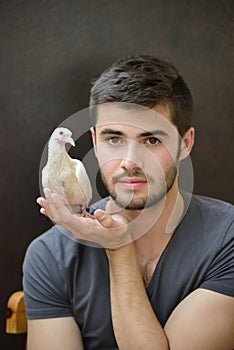 Young man helping rescue a baby pidgeon