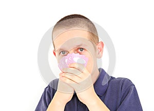 Young man hiding behind cards