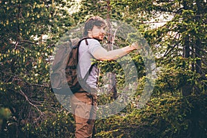 Young Man hiking in forest with backpack Travel Lifestyle