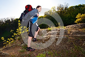 A young man hiking in the forest. Travel, hike, backpacking, to