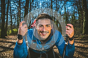 Young man is hiking in the woods. photo