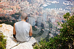 Young man on a hill above Monaco, contemplating the view