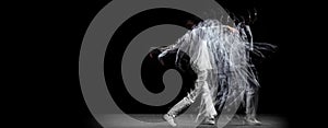 Young man, hip-hop dancer in action, motion isolated on dark background with sroboscope effect. Youth culture, hip-hop