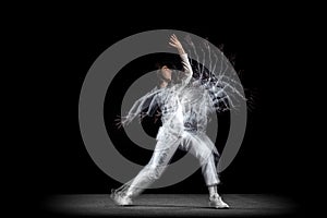 Young man, hip-hop dancer in action, motion isolated on dark background with sroboscope effect. Youth culture, hip-hop