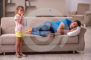 Young man with his daughter at home