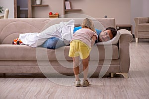 Young man with his daughter at home