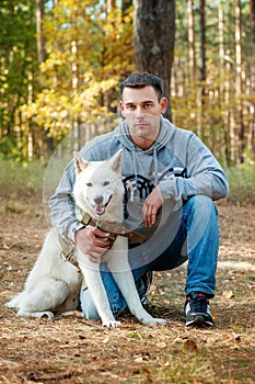 Young man and his dog akita inu - man`s best friend