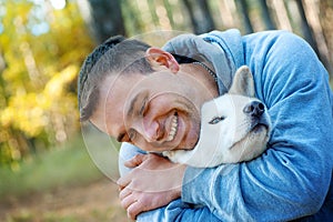 Young man and his dog akita inu - man`s best friend