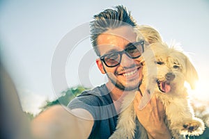 Young man and his dog taking a selfie