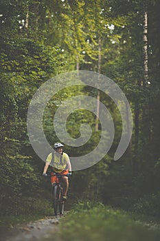 Young man with his mountain bike going for a ride past