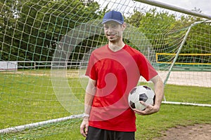 Young man hold soccer ball