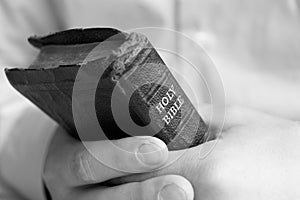 Young man holding bible