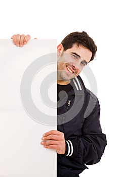 Young man holding blank billboard