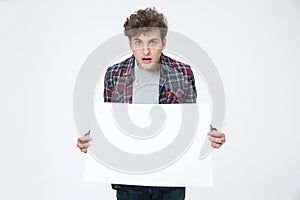 Young man holding blank paper