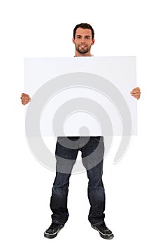 Young man holding blank white sign photo