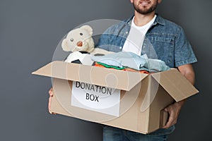 Young man holding box with donations