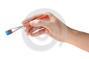 Young man holding brush with color paint on white background