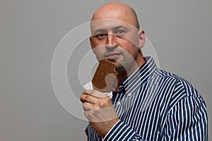 Young man holding a chocolate bar