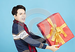 Young man holding Christmas gift box