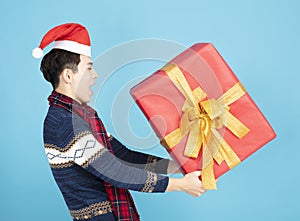 Young man holding Christmas gift box