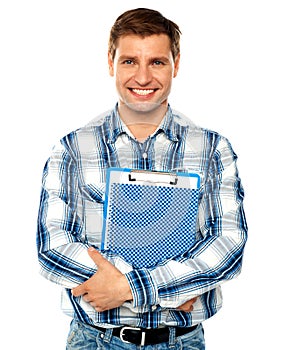 Young man holding clipboard and notepad