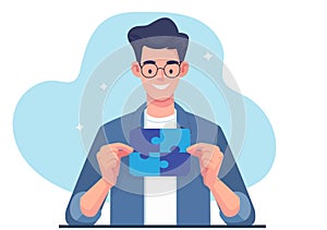 A young man is holding a completed jigsaw puzzle