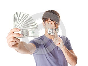 Young man holding a dollar bills his mouth sealed