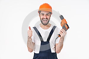 Young man holding drill showing thumbs up gesture