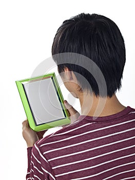 Young man holding an empty picture frame